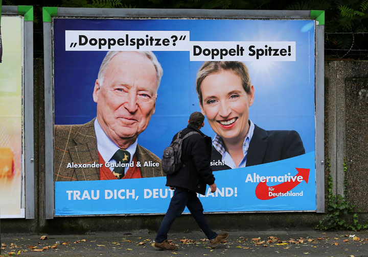 A man looks at at a placard of Alexander Gauland and Alice Weidel, the top candidates of Germany’s anti-immigration party Alternative fuer Deutschland (AfD) ahead of the September 24 German federal election.