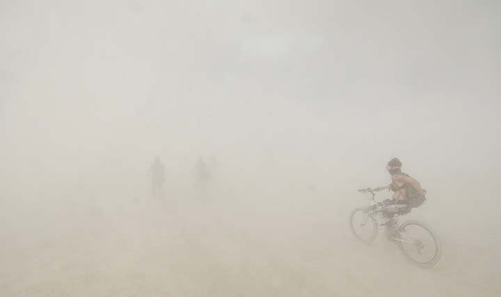 Burning Man participants bicycle through a desert dust storm as approximately 70,000 people from all over the world attend the 3rd day of the annual Burning Man arts and music festival in the Black Rock Desert of Nevada, August 30, 2017.