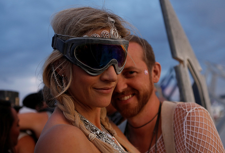 Pippa Sutherland (L) and AJ Bertenshaw dance during the Burning Man arts and music festival in the Black Rock Desert of Nevada, August 29, 2017.