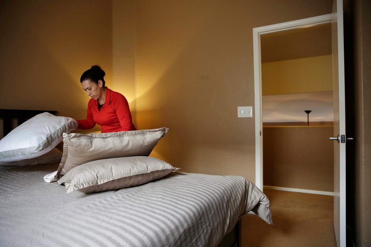 In this file photo a woman cleans a home that is rented out for short-term rentals, Monday, September 18, 2017.