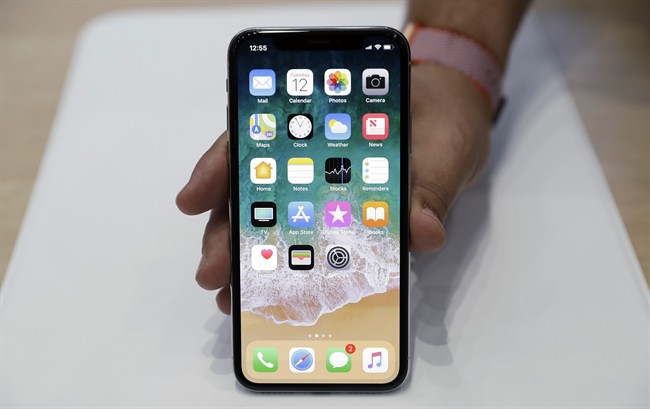 FILE - In this Tuesday, Sept. 12, 2017, file photo, the new iPhone X is displayed in the showroom after Apple's new product announcement.