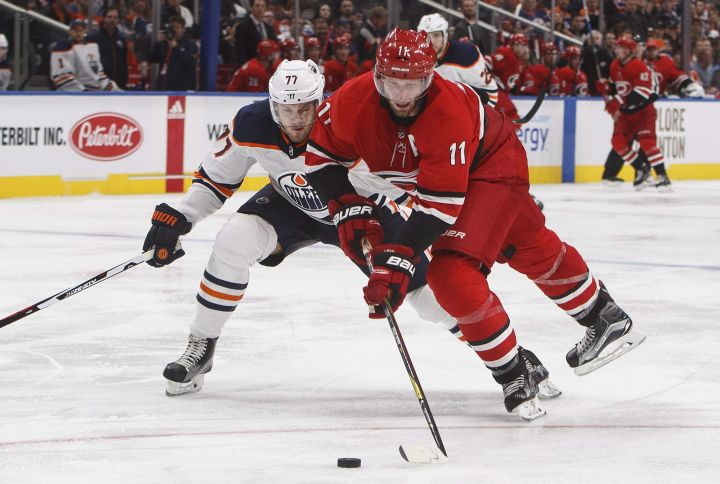 Carolina Hurricanes' Jordan Staal (11) and Edmonton Oilers' Oscar Klefbom, of Sweden, (77) battle for the puck during third period preseason NHL action in Edmonton, Alta., on Monday September 25, 2017. 