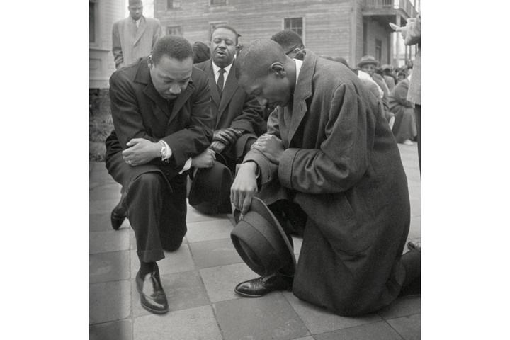 Civil rights leader Martin Luther King Jr. kneels with a group in prayer prior to going to jail in Selma, Alabama.