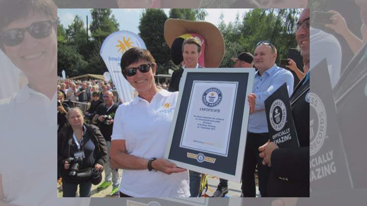 Patricia Leguen holds her certificate from Guinness World Records as part of the team that constructed the world’s tallest sandcastle.