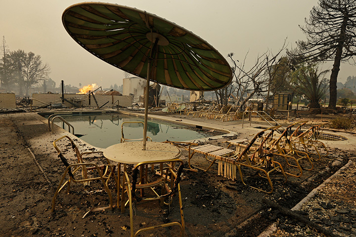Fire burns from an open gas valve near the pool area at a trailer park on Monday, Oct. 9, 2017, in Santa Rosa, California.