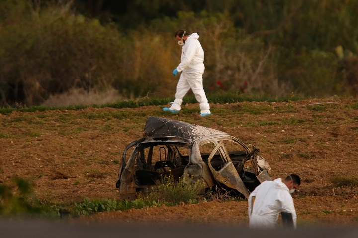 Forensic experts search for clues in a field after a powerful bomb blew up a car and killed investigative journalist Daphne Caruana Galizia in Bidnija, Malta, on October 16, 2017. 