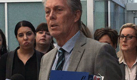 Mayor Fred Eisenberger holds a copy of Hamilton's Amazon HQ2 bid book.