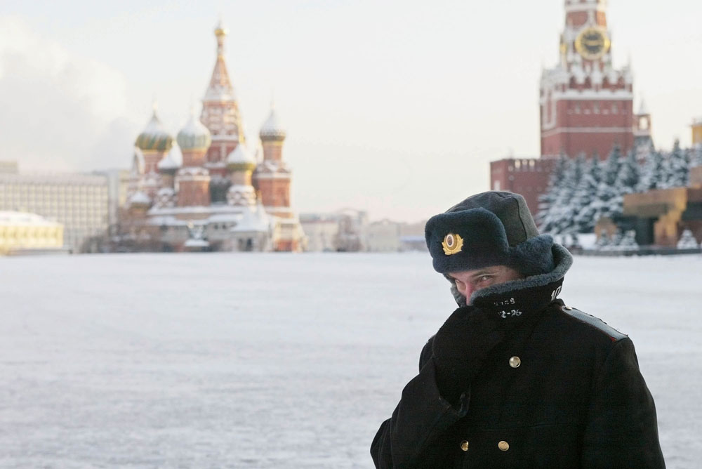 A Russian police officer, braving the bitter cold, patrols Red Square with the Kremlin in the background in this file image. 