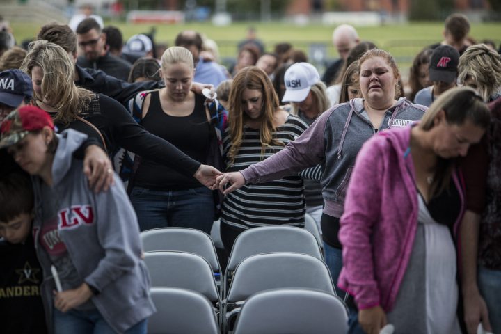 People gather at the Ascend Amphitheater for a vigil honoring the victims of the mass shooting in Las Vegas on Oct. 2, 2017 in Nashville, Tennessee.