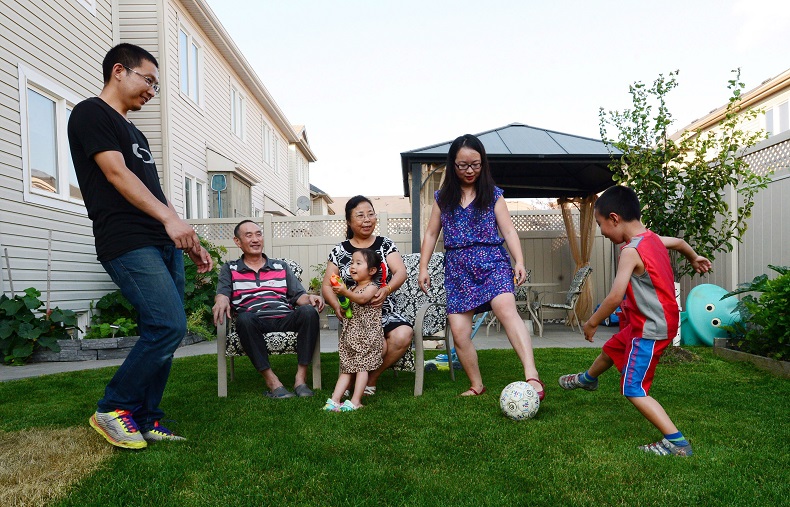 Yi Jiang, Jianqiao Sun, their son Sunny, their daughter Jenny and grandparents Youfang Jiang and Li Zhang are pictured at their home in Ottawa in July. The family immigrated to Canada from China and live together as a multi-family household.
