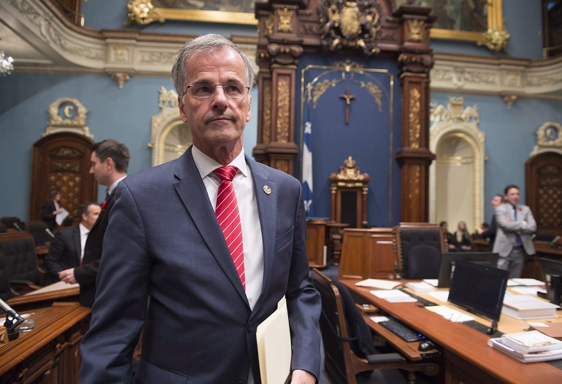 Guy Ouellette is demanding $250,000 for harm to his reputation, $200,000 for moral prejudice and $100,000 in monetary losses, according to court documents filed by his lawyer in Quebec Superior Court.