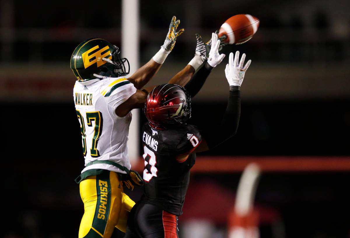 Calgary Stampeders’ Ciante Evans (0) knocks the ball away from Edmonton Eskimos’ Derel Walker late in the fourth quarter during CFL West Final football action in Calgary, Sunday, Nov. 19, 2017.THE CANADIAN PRESS/Todd Korol