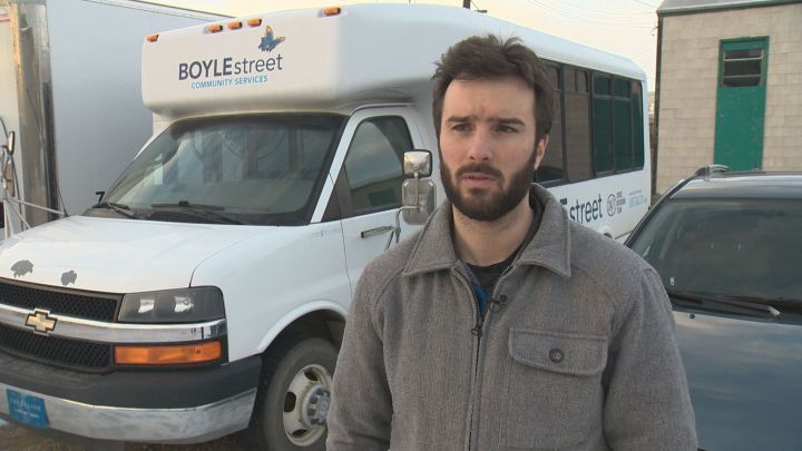 Aidan Inglis, director of programs at Boyle Street Community Services, stands in front of the organization's warming bus on Nov. 28, 2017.