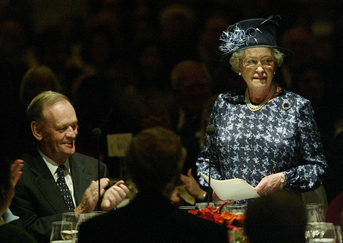 Canadian Prime Minister Jean Chretien listens to a speech by Queen Elizabeth during a luncheon in Vancouver October 7, 2002. 