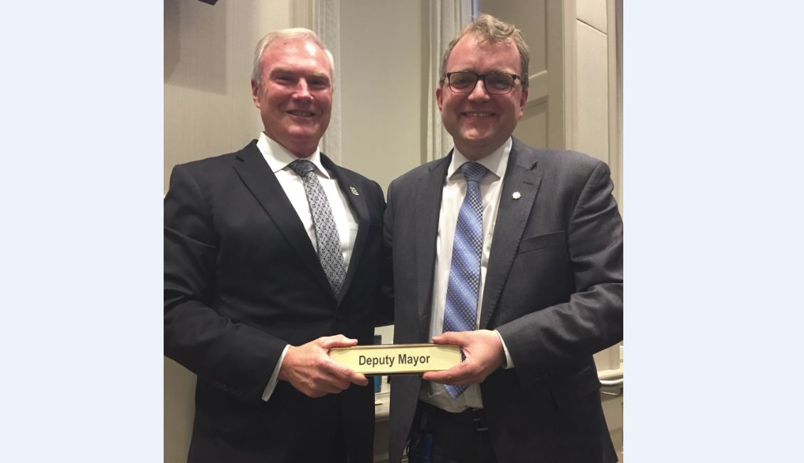 Steve Craig hands over the deputy mayor duties to Waye Mason at Tuesday's Halifax Regional Council meeting. Fellow councillor Tony Mancini snapped this photo.  