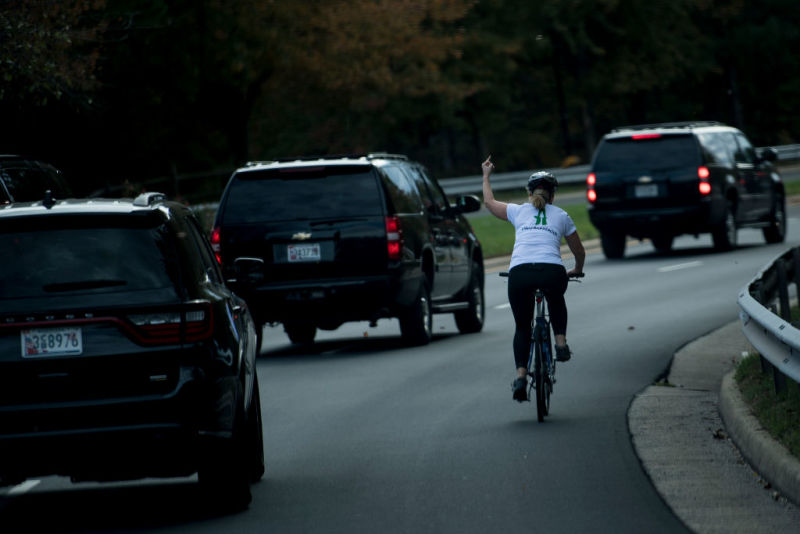 Juli Briskman was on her bicycle last month when Trump's motorcade drove by. A photo that quickly went viral shows her raising the middle finger of her left hand in defiance.