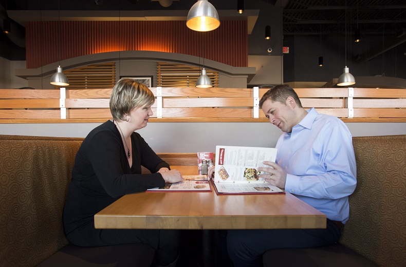 Andrew Scheer, right, looks over a menu with his wife Jill at a restaurant in Ottawa on Monday Dec. 11, 2017.