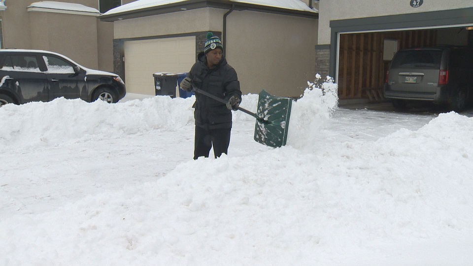 A Winnipegger shovels snow in this file photo.