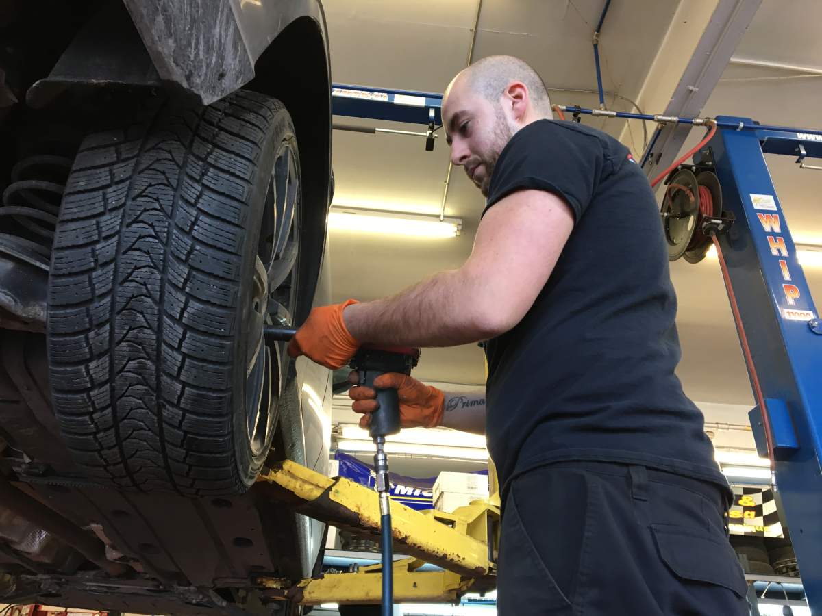 John Massa installing winter tires at Garage Donati & Massa.