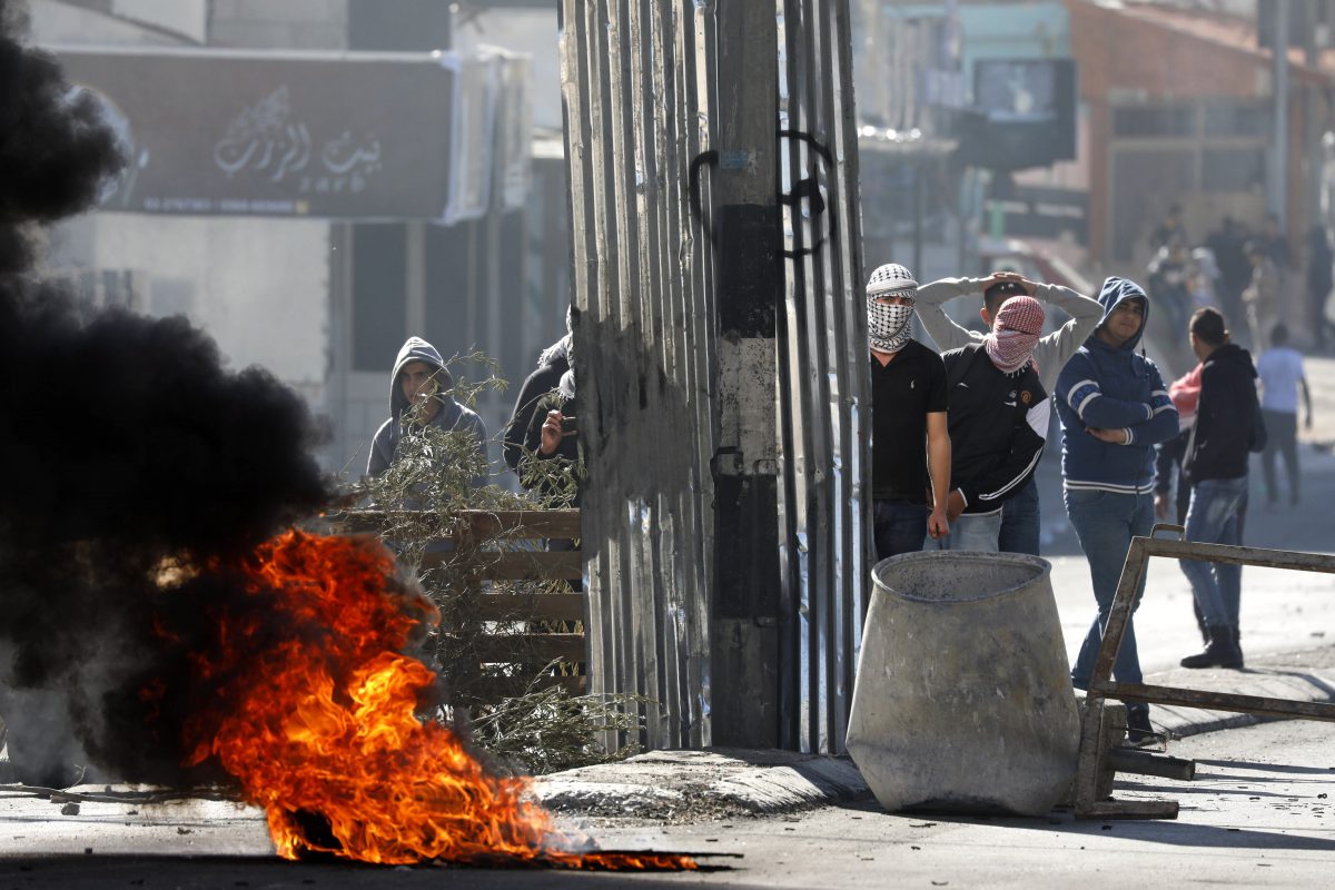 Palestinians throw stones at Israeli troops during clashes in the West Bank City of Bethlehem, 09 December 2017.