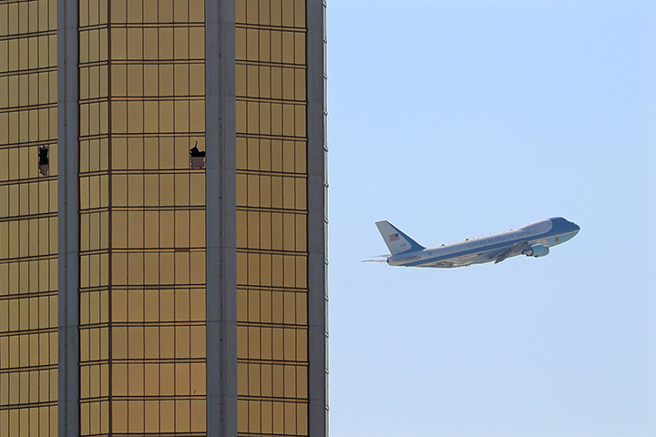 Air Force One departs Las Vegas past the broken windows on the Mandalay Bay hotel, where shooter Stephen Paddock conducted his mass shooting along the Las Vegas Strip in Nevada, October 4, 2017.
