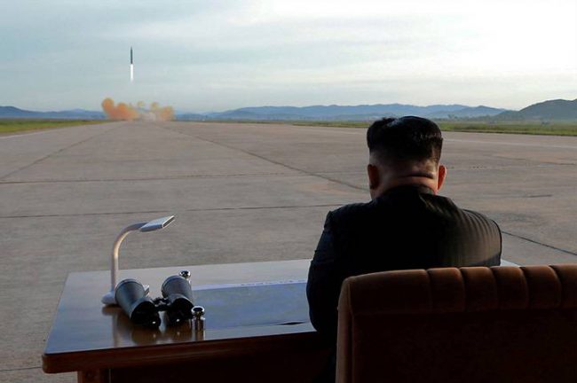 North Korean leader Kim Jong Un watches the launch of a Hwasong-12 missile in this undated photo released on Sept. 16, 2017.