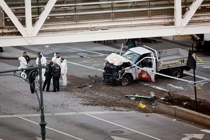 Authorities stand near a damaged Home Depot pickup truck after its driver drove onto a bike path near the World Trade Center memorial in New York, striking and killing several people on Oct. 31, 2017.