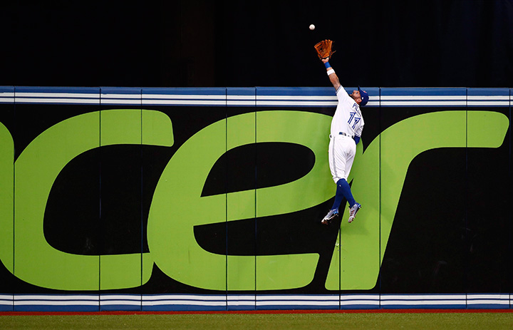 Toronto Blue Jays centre fielder Kevin Pillar climbs the wall but can’t make the catch on a solo home run by New York Yankees catcher Gary Sanchez on Wednesday, August 9, 2017.