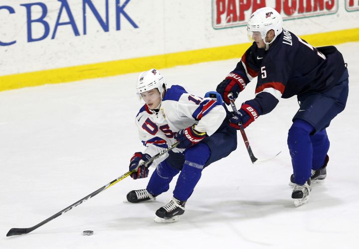In this Sunday, Dec. 17, 2017 photo, United States' Ryan Lindgren, right, checks Kailer Yamamoto during hockey practice in Columbus, Ohio. Expectations will be high when the US under-20 team defends its title on home soil at the World Junior tournament, starting the day after Christmas in Buffalo, N.Y. 