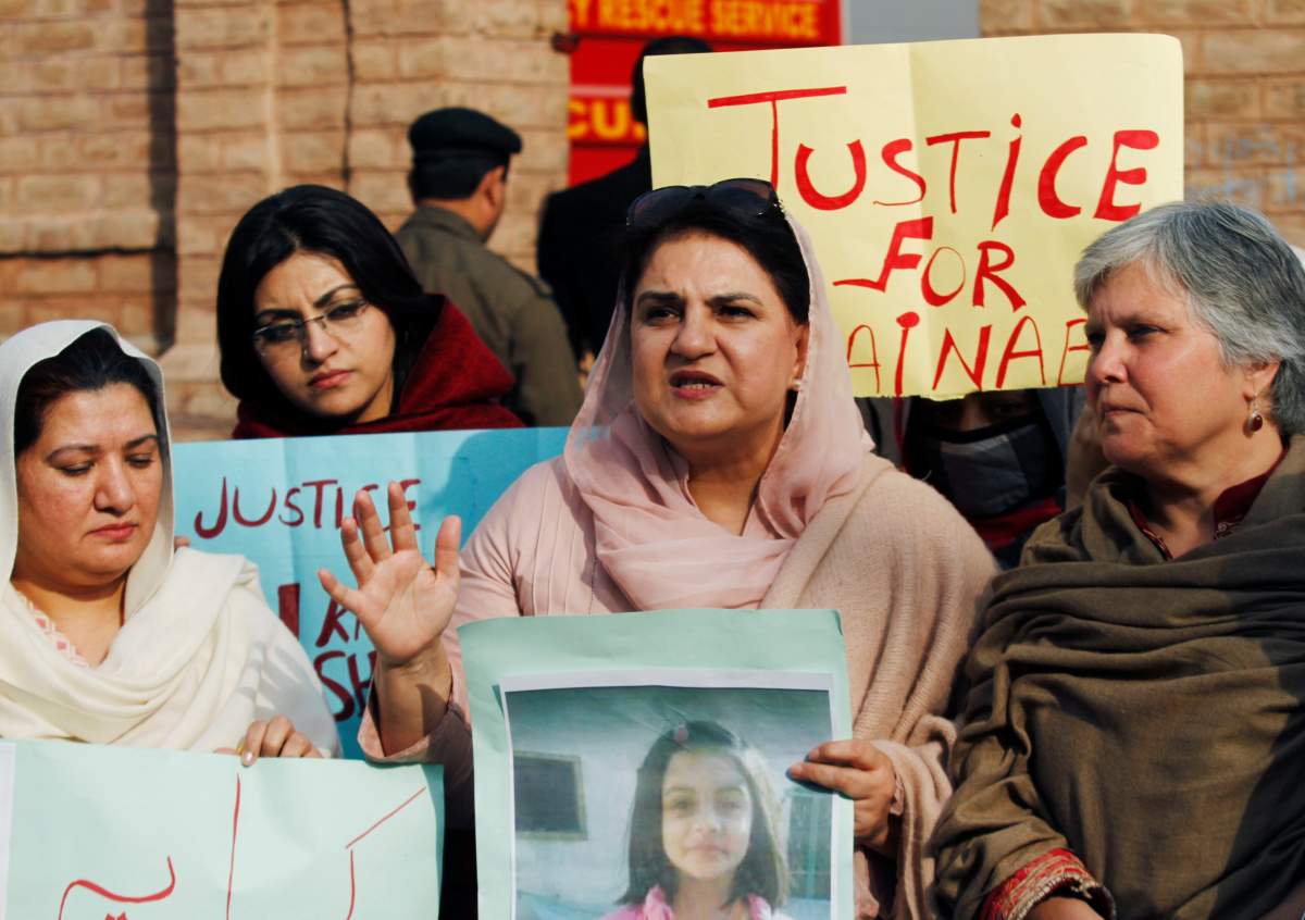 People hold signs to condemn the rape and killing of 7-year-old girl Zainab Ansari in Kasur, during a protest in Peshawar, Pakistan.