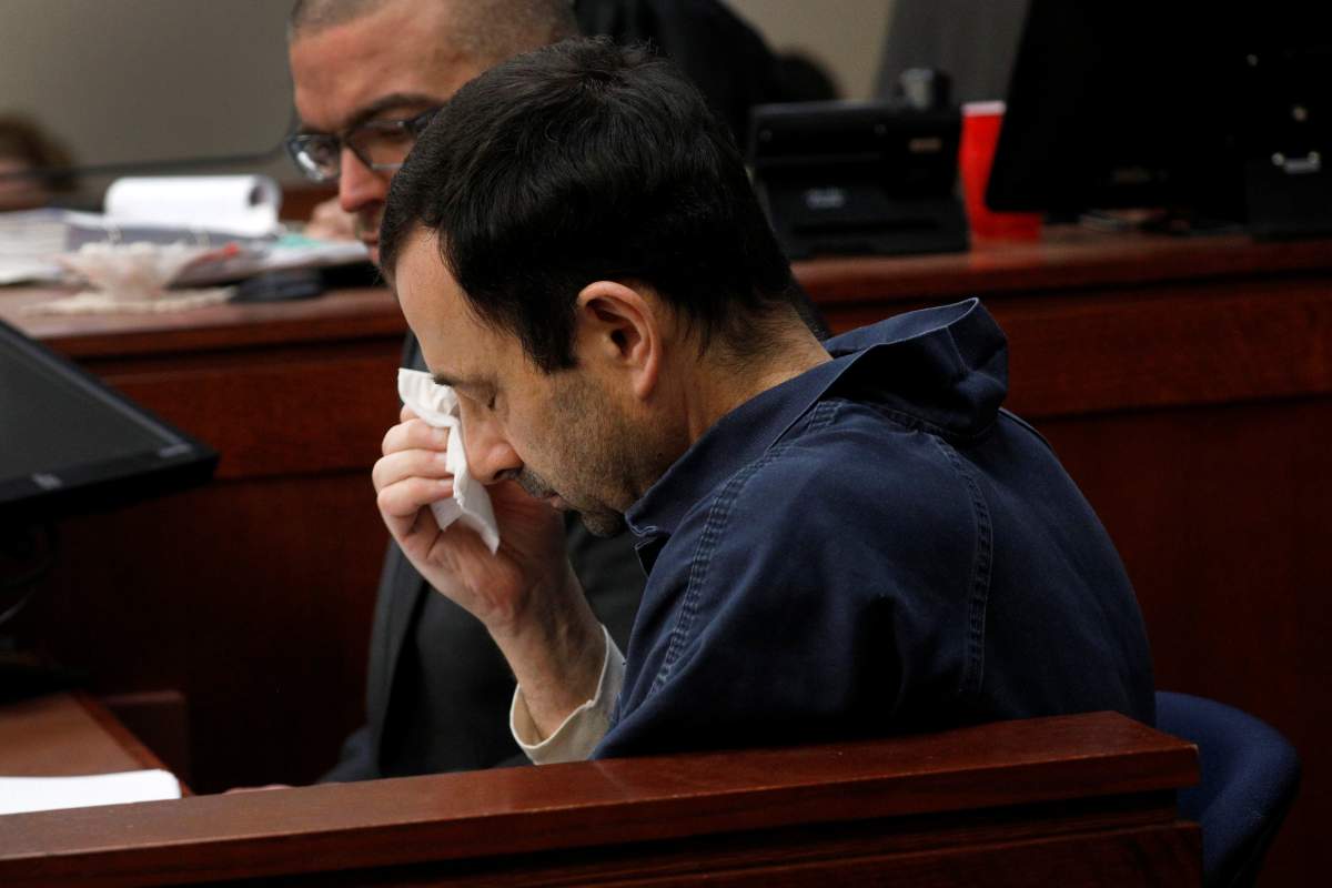 Larry Nassar wipes his face as he sits in the courtroom during his sentencing hearing in Lansing, Michigan, U.S., January 18, 2018.