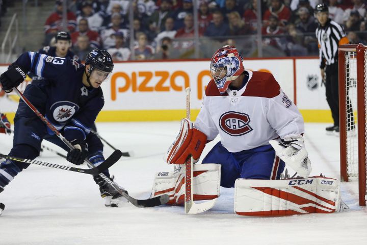 Winnipeg Jets' Brandon Tanev (13) attempts to get the puck past Montreal Canadiens goaltender Al Montoya (35) during second period NHL action in Winnipeg on Saturday, November 4, 2017. 