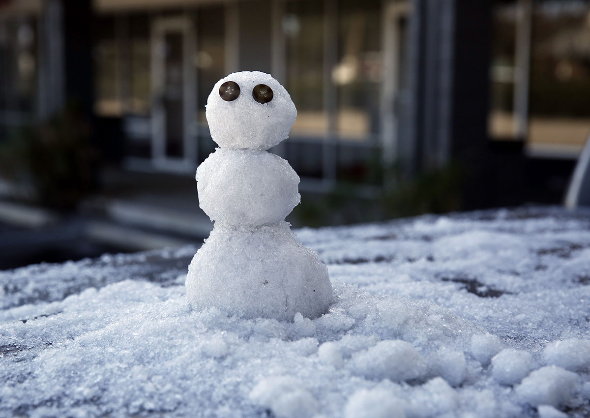 A snowman, built by Marty Ritter, sits on the back of his truck outside Morrow Cleaners, Wednesday, Jan. 3, 2018, in Tallahassee, Fla.