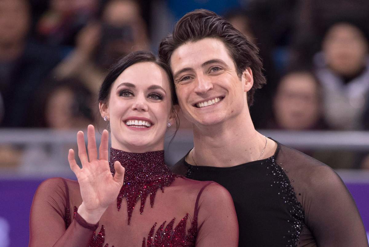 Ice dance gold medalists Canada's Tessa Virtue and Scott Moir look up to the crowd during victory ceremonies at the Pyeongchang Winter Olympics Tuesday, Feb. 20, 2018, in Gangneung, South Korea.