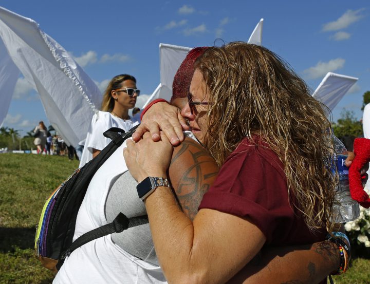 Pulse shooting survivor India Godman, left, hugs Wendy Garrity at Marjory Stoneman Douglas High School.