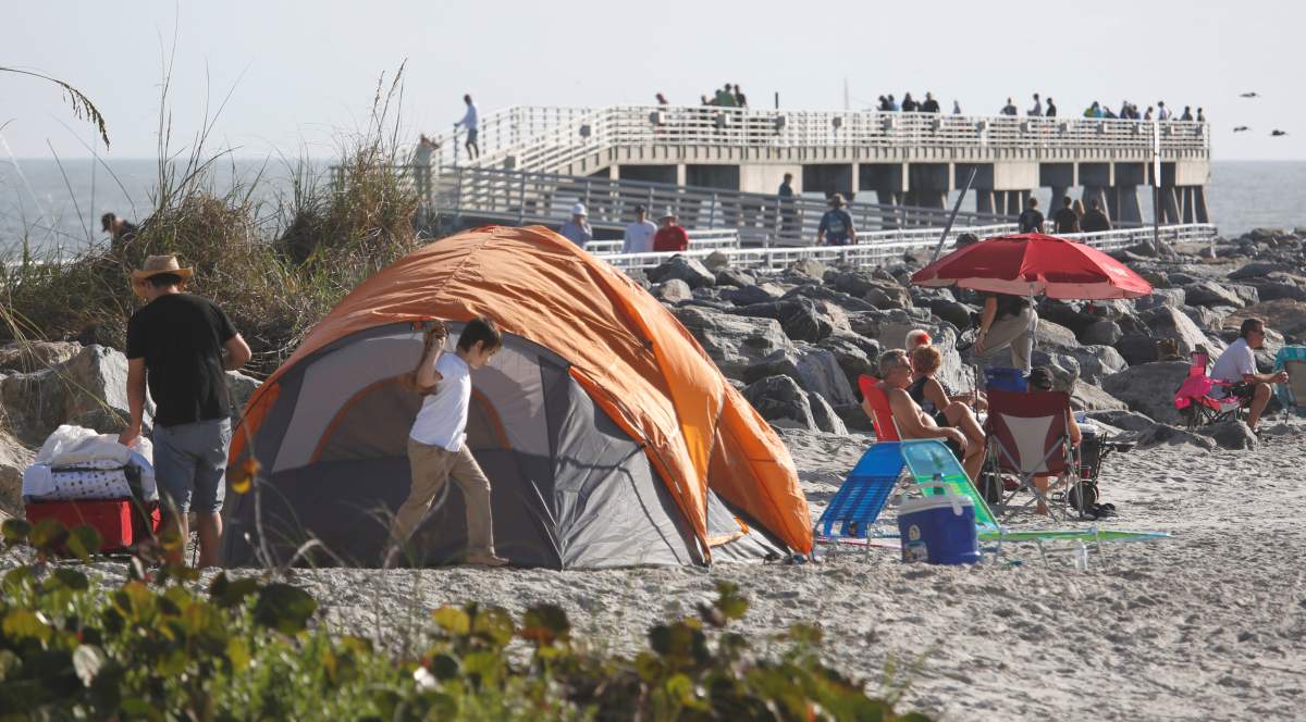 Visitors stake out spots near the fishing pier at Jetty Park and Cocoa Beach to watch SpaceX’s first Falcon Heavy rocket launch from the Kennedy Space Center, Florida.