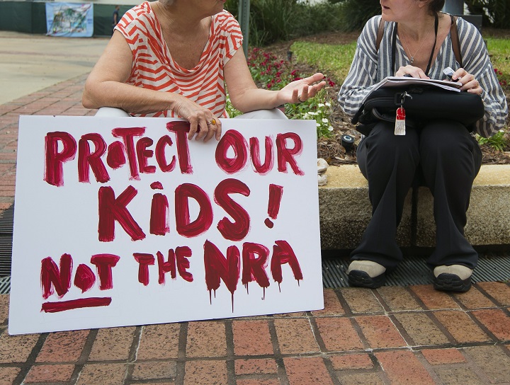 A woman holds a sign at the Florida state Capitol in Tallahassee, Florida, USA, 21 February 2018. Seventeen people were killed by a gunman at Marjory Stoneman Douglas High School 14 February 2018, in Parkland, Florida. Students, parents and others are calling for legislative changes to gun access.