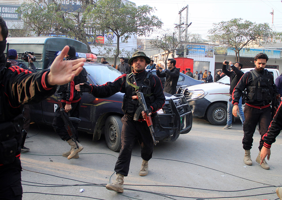 Police clear journalists out of the way for a police van carrying Imran Ali suspected to be a serial killer responsible for the rape and murder of a seven-year-old girl to the anti terrorism court in Lahore, Pakistan.