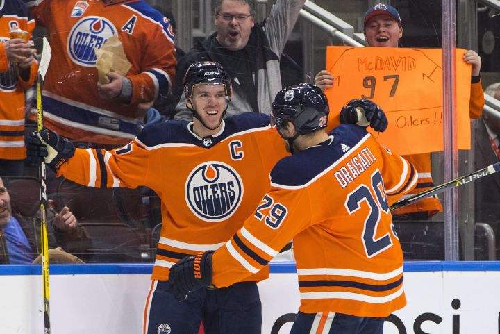 Edmonton Oilers' Connor McDavid (97) and Leon Draisaitl (29) celebrate a goal against the Tampa Bay Lightning during second period NHL action in Edmonton, Alta., on Monday February 5, 2018. 