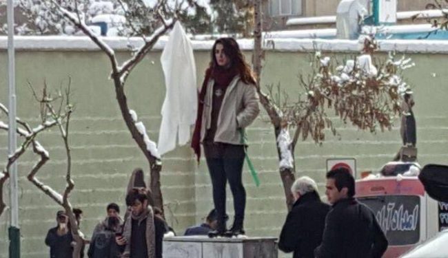 Protester Narges Hosseini holds up her white headscarf to protest Iran’s mandatory hijab laws, in this undated photo.