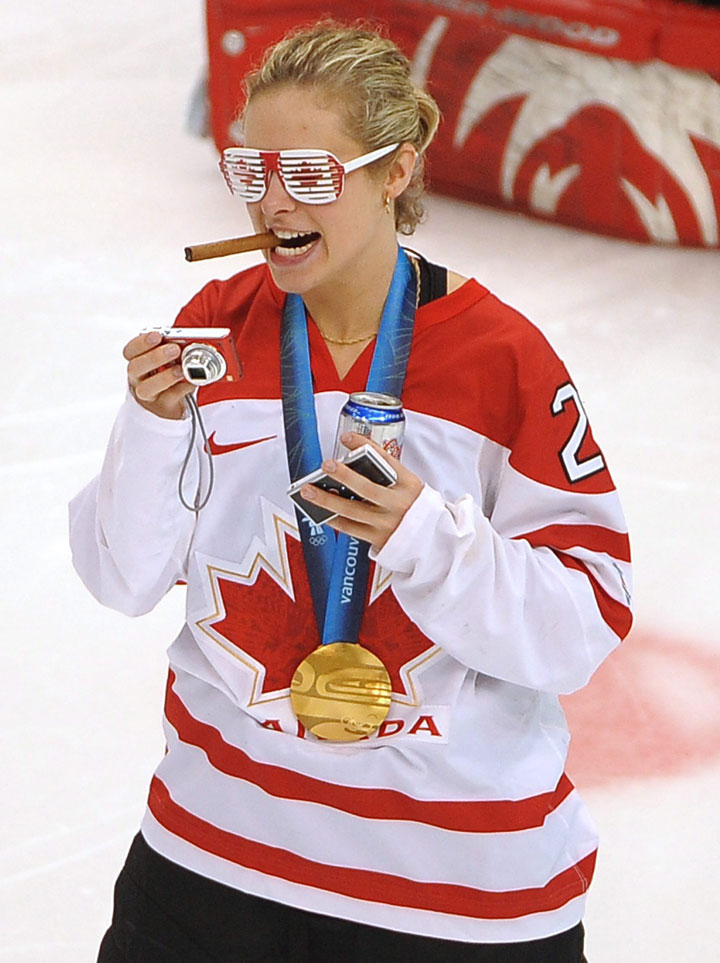Canada’s Tessa Bonhomme wears Canadian flag glasses and smokes a cigar as she celebrates on the ice with teammates after Canada defeated the USA 2-0 in the Women’s Olympic hockey gold medal game at Canada Hockey Place Thursday Feb. 25, 2010 at the 2010 Vancouver Olympic Winter Games.