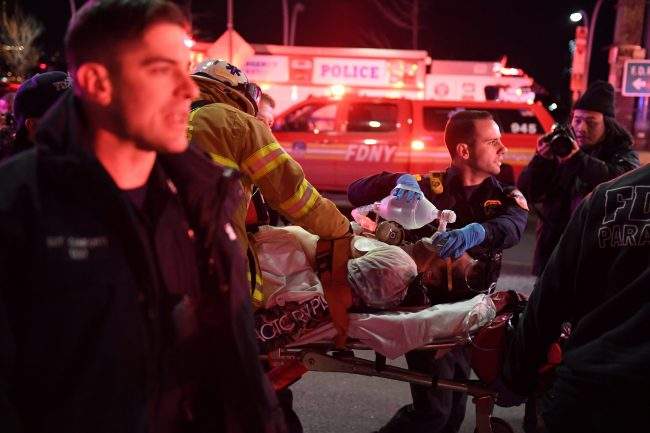 Paramedics and members of the NYFD perform CPR on a victim of a helicopter crash in New York, U.S., March 11, 2018.