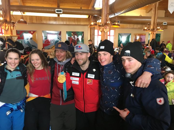 Olympic medallist Brady Leman flanked by young skiers at Nakiska Ski Area on March 9, 2018.