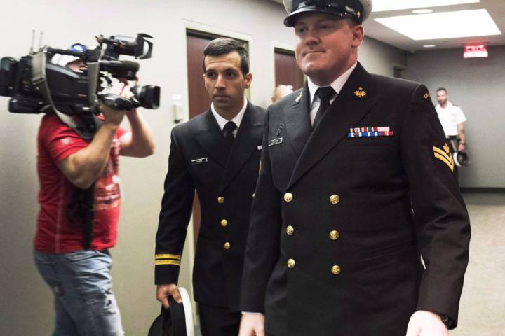 FILE – Accused Master Seaman Daniel Cooper, right, arrives for his standing court martial case.