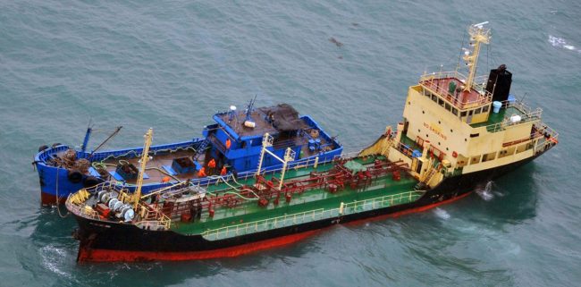 This Feb. 16, 2018 photo released by Japan’s Ministry of Foreign Affairs shows what Japan says is a North Korean-flagged tanker lying alongside a small vessel of unknown nationality in the East China Sea, some 250 km east of Shanghai.