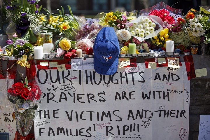 Tributes are seen on a memorial at Yonge St. and Finch Ave. in Toronto on Thursday, April 26, 2018 for the victims of Monday's deadly van attack. 