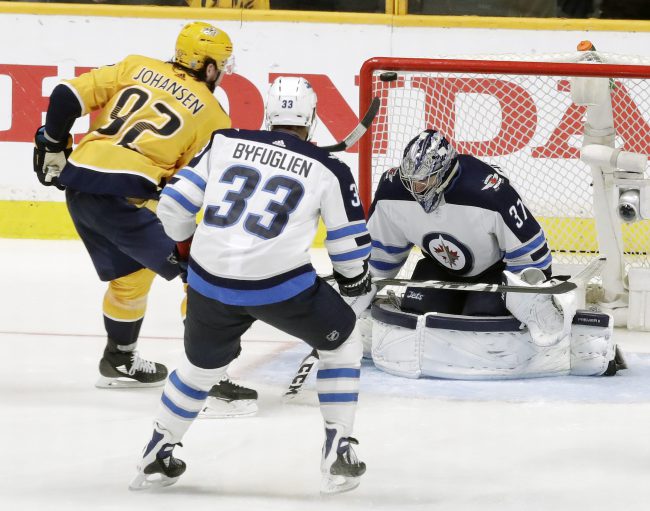 Nashville Predators center Ryan Johansen (92) scores a goal against Winnipeg Jets goalie Connor Hellebuyck (37) during the third period in Game 2 of the second-round playoff series, Sunday, April 29, 2018, in Nashville, Tenn.