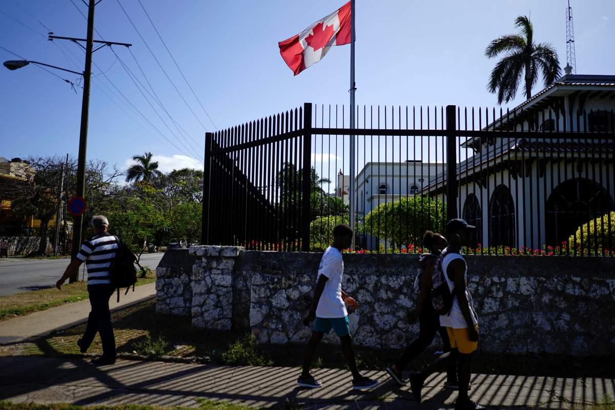 People pass by the Canada's Embassy in Havana, Cuba, April 16, 2018. 
