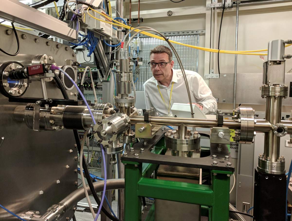 Professor John McGeehan, an X-ray Crystallographer at the University of Portsmouth, stands next to equipment at the Diamond Light Source, the UK national synchrotron, that he used to reveal the atomic structure of an enzyme his team has subsequently engineered that can digest a common form of plastic.