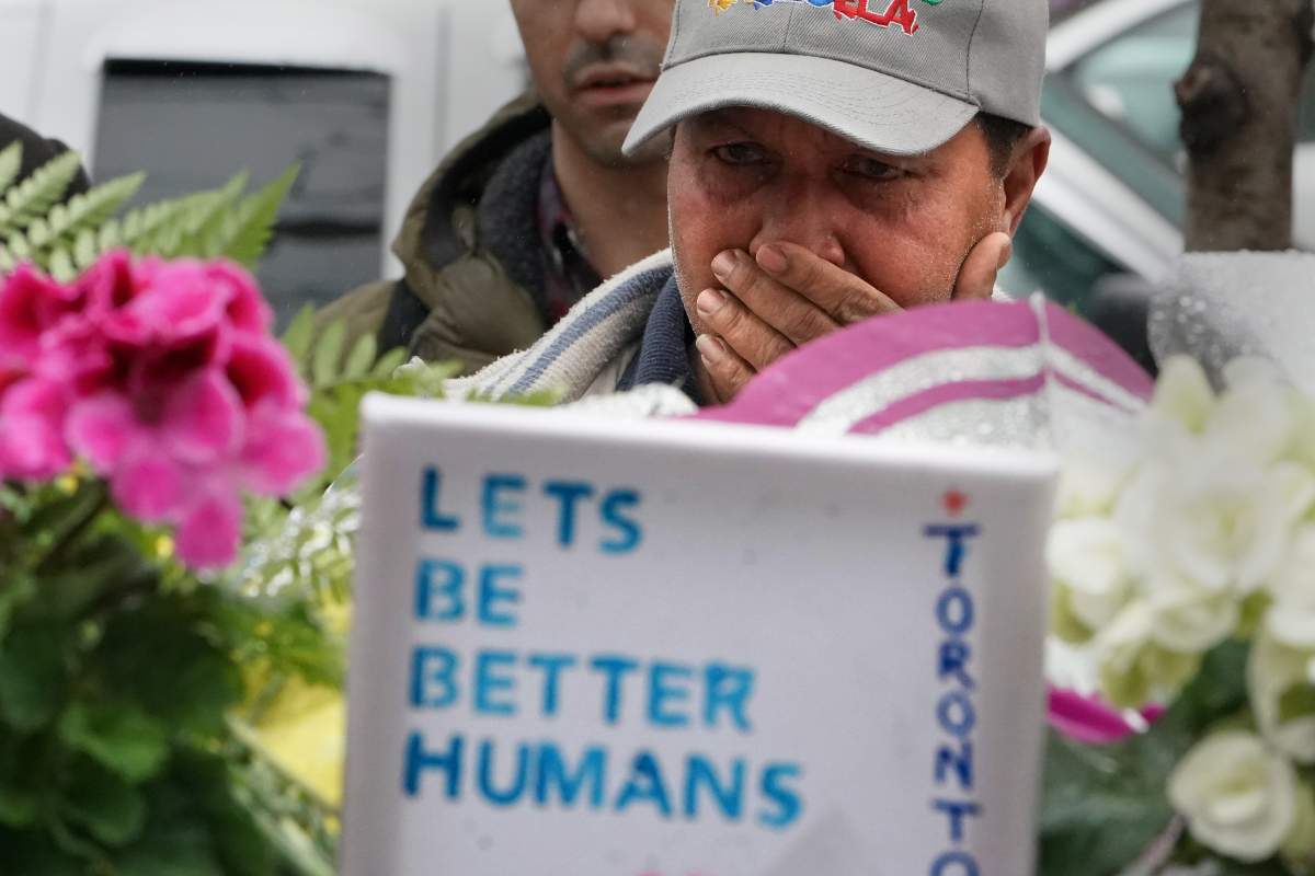 A man cries as he pays his respects at a makeshift memorial on Yonge Street following a van that attacked multiple people in Toronto, Ontario, Canada, April 25, 2018. 